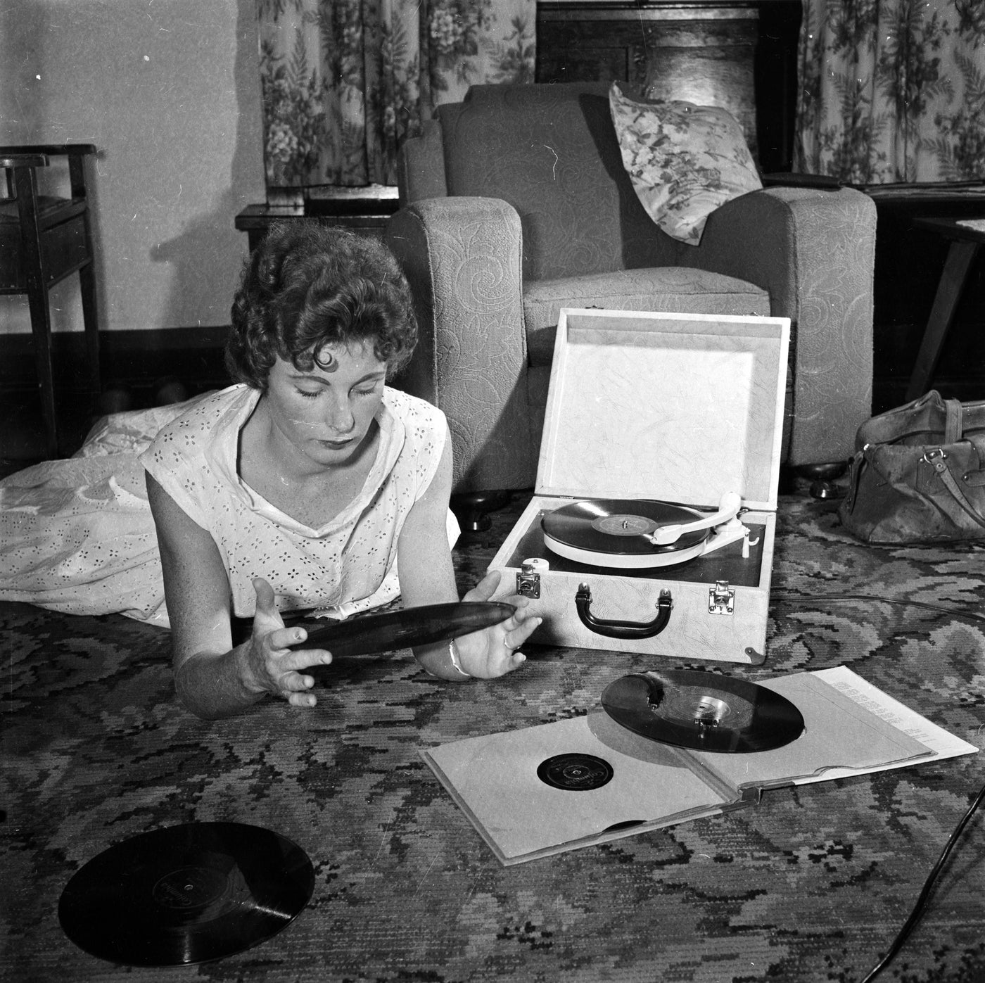 Womens with old tunrtable listening to records