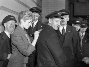 Actress signing autograph on mans back with a piece of paper